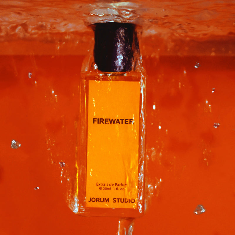 Bottle of Jorum Studio Firewater with water pouring over it upside down