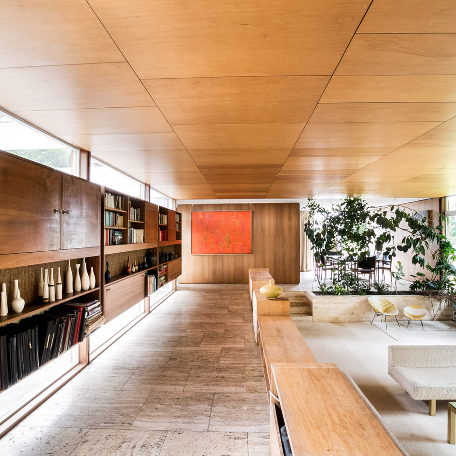 View of the living area of Klein House, with wood panelled ceiling and built in wooden cabinets