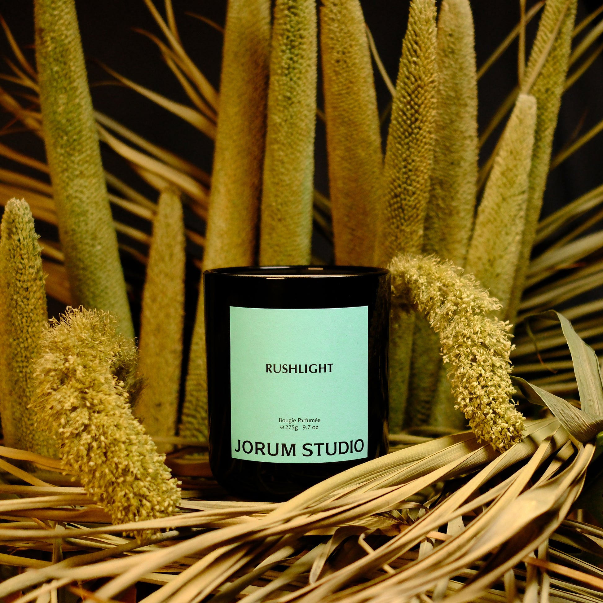 Jorum Studio Rushlight candle arranged within a bouquet of grasses and reeds